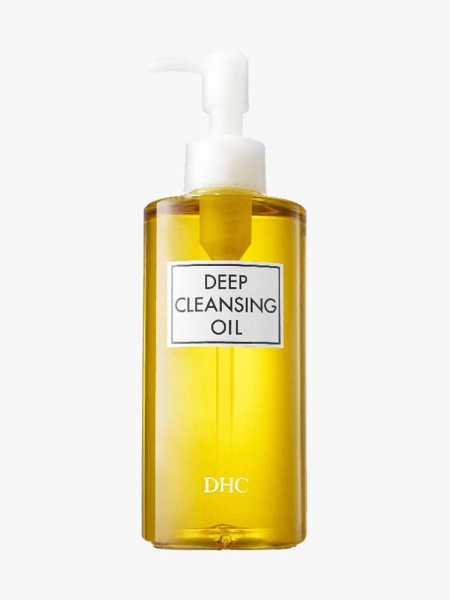 DHC Deep Cleansing Oil bottle of yellow cleansing oil with white pump cap on light gray background